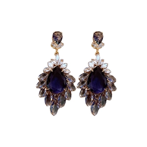 Vintage gold earrings with large blue teardrop zircons and champagne crystals