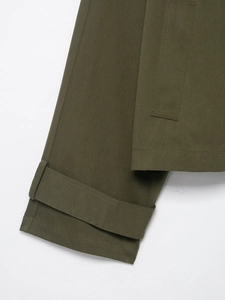 Detail of olive green twill cotton sleeve cuff with adjustable strap and reinforced stitching