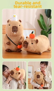 Detailed close-up of brown plush capybara toy with cute orange bag and soft texture
