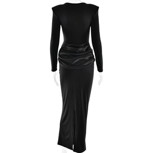 Detail view of black dress featuring padded shoulders, ruching and high slit on back side