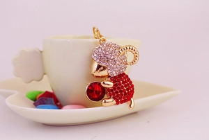 Detailed macro view of a golden monkey keychain with sparkling red crystals and rhinestones