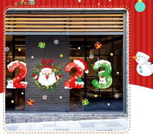 Detail of 2023 Christmas window stickers with Santa Claus, wreaths, and festive gift boxes