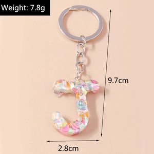 Detail view of resin letter J keychain with soft multicolor flakes and dimensions