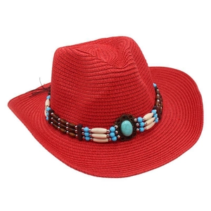 Detail of red straw cowboy hat featuring bohemian turquoise and bead band ornament