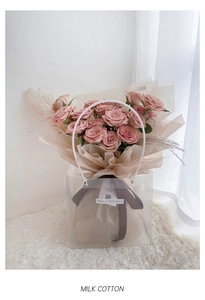 Detail view of handmade pink milk cotton crochet roses in a transparent gift carrier bag