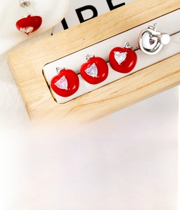 Macro detail of red apple stud earring with heart zircon in 0.8x6mm titanium steel