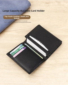 Macro shot of black lychee grain genuine leather business card holder on wooden desk