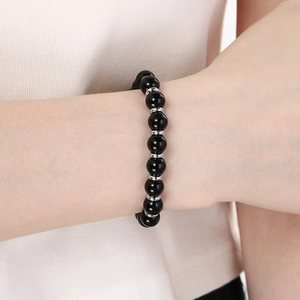 Detailed view of tiger eye and lava stone beaded bracelet worn on a wrist