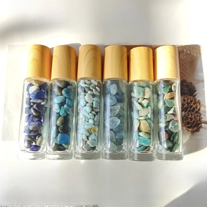 Set of six glass essential oil roller bottles with natural crystal stones and wood caps