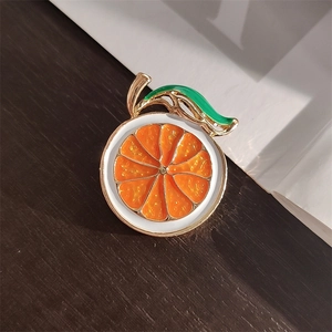 Fashionable orange slice enamel brooch with gold alloy frame and vibrant green leaf