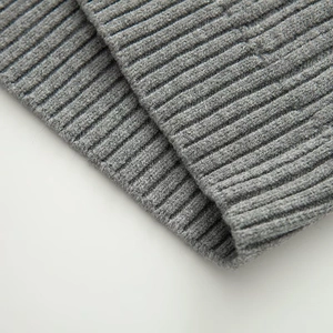 Macro view of grey ribbed knit cuffs and hem showing high-quality fabric texture