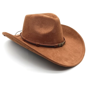 Detailed close-up of brown suede cowboy hat with woven cord and vintage metal buckle