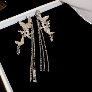 Detailed macro shot of silver butterfly tassel earrings with sparkling teardrop crystals
