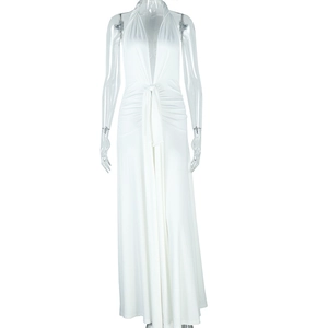 Detail of white halter neck maxi dress featuring deep V-neck and waist tie design
