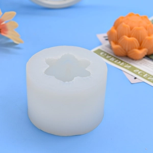 Macro detail of silicone mold with intricate lotus petal textures and orange wax sample