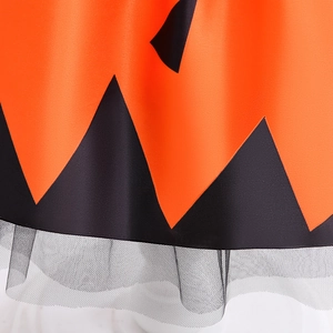 Close-up of orange and black jagged hemline with tulle layers for Halloween girl dress
