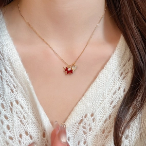 Close-up of a model wearing a gold plated necklace with red heart-shaped zircon pendant