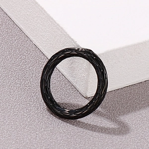 Close-up of black mesh grid texture on a stainless steel vintage ring design