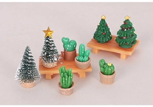 Miniature Christmas trees and cactus figurines on wooden stools for DIY desk decor