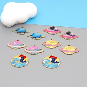 Macro detail of enamel planet and whale charms for DIY jewelry making accessories