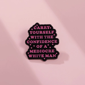 Pink enamel badge with confidence quote on a matching pink background and metal base
