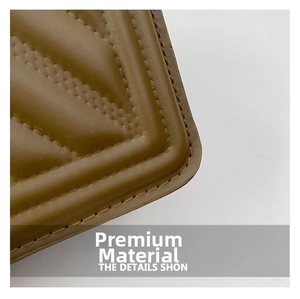 Detailed close-up of premium brown leather bag showing chevron quilting and precise stitching