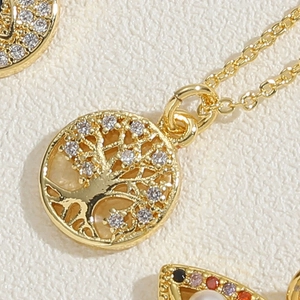 Detailed view of a gold-plated Tree of Life pendant with sparkling zircon leaf accents