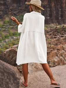Back view of a loose white cotton linen polo shirt dress for vacation and leisure