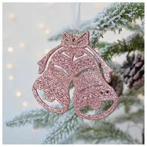 Close-up of pink glitter Christmas bell ornaments with ribbon bow on pine tree branch