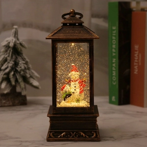 Vintage Christmas lantern with snowman and penguin scene, sparkling lights and snow effect