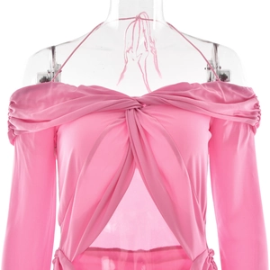 Detail of pink off-shoulder top featuring front twist knot and stylish cutout detail