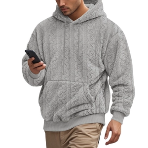Detailed texture of gray men's fleece hoodie featuring cable knit pattern and kangaroo pocket
