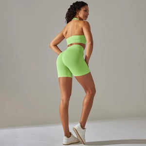 Macro detail of seamless ribbed texture on lime green yoga bra and high-waist shorts
