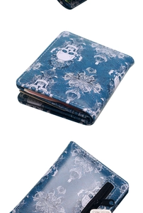 Detail of blue skull and floral print wallet with leather texture and zip closure