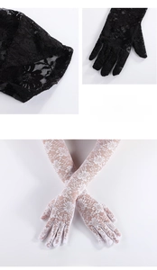 Close-up of black and white long lace gloves with delicate floral patterns for sun protection