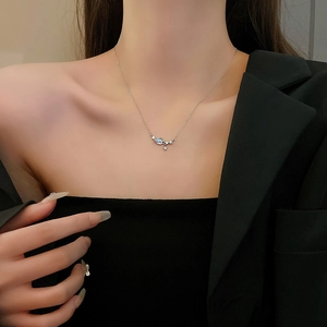 Detail of silver clavicle chain with moonstone effect pendant and sparkling star charm