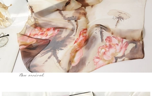 Close-up of lightweight floral silk scarf with pink lotus ink painting and soft texture