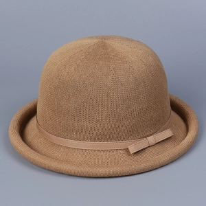 Detail of breathable knit texture and elegant ribbon bow on khaki round dome hat