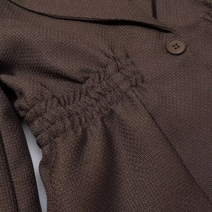 Women's deep V-neck long sleeve blazer in dark brown textured woven fabric with waist tie