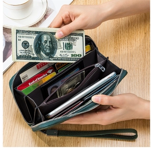 Interior view of green leather long wallet showing card slots and coin pocket storage