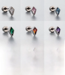 Macro display of kite-shaped titanium steel studs with colorful cubic zirconia stones