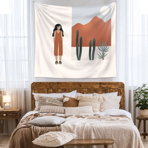 Detail of bohemian tapestry with desert landscape and woman figure in a cozy bedroom