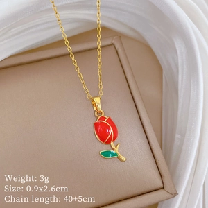 Detail of gold tulip pendant with red flower and green leaves on a 40cm chain
