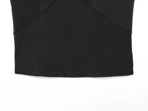 Detailed view of the black fabric hem with fine stitching and smooth plain weave texture