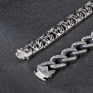Close-up of vintage silver stainless steel bracelets with embossed punk patterns