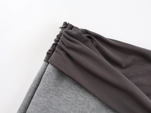 Detailed macro view of the invisible zipper and high-quality gray patchwork knit fabric