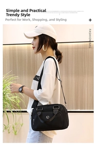 Fashionable black nylon tote bag with adjustable strap and large capacity on female model