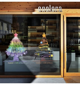 Detail of Christmas tree window stickers with colorful artistic patterns and holiday greetings