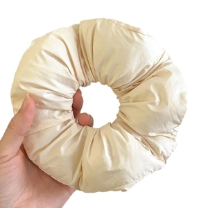 Oversized cream fabric scrunchie with pleated design and soft fluffy texture for women