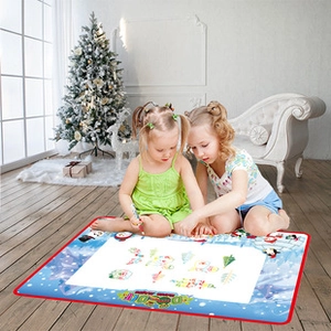 Kids using magic water doodle mat with festive winter penguin theme and Christmas tree